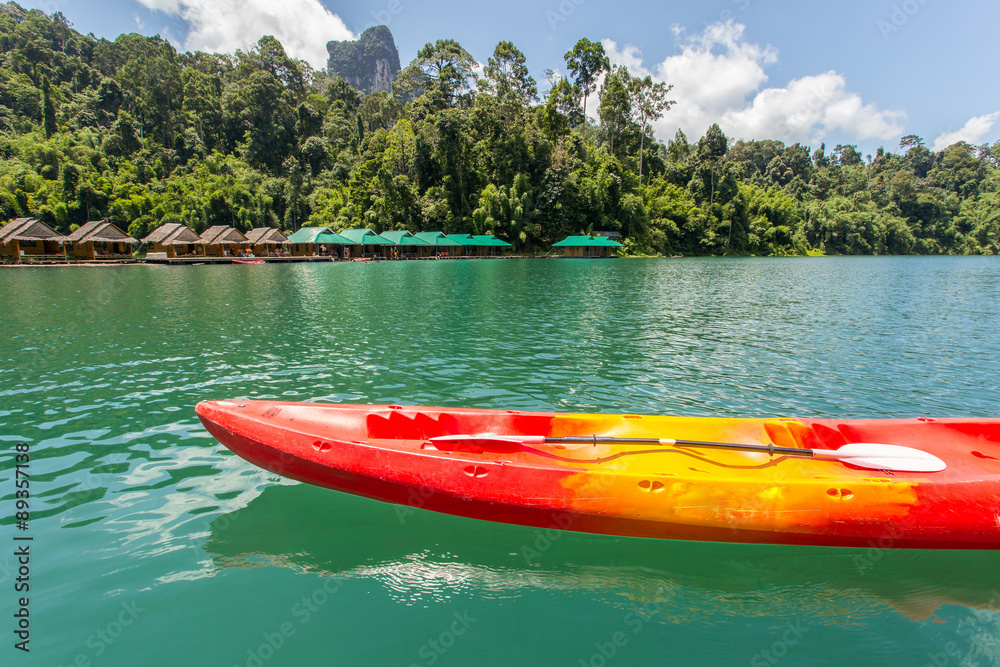 Canoe in a beautiful mountains lake forest and river natural attractions in Ratchaprapha Dam at Khao Sok National Park, Surat Thani Province, Thailand. Canoe in a beautiful mountains lake forest and river natural attractions in Ratchaprapha Dam at Khao Sok National Park, Surat Thani Province, Thailand.