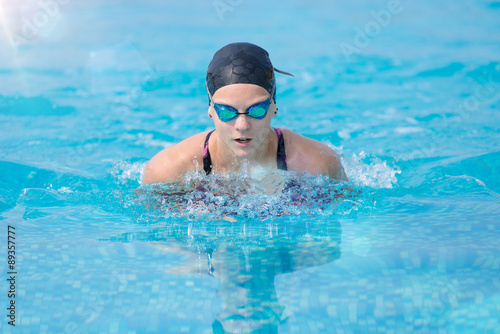 Young girl swimming butterfly stroke style © mr.markin