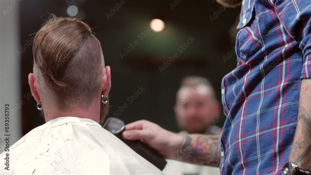 beard barber making haircut to hipster client beard barber making haircut to hipster client