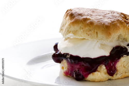 Obraz na plátně Jam and cream scones on white