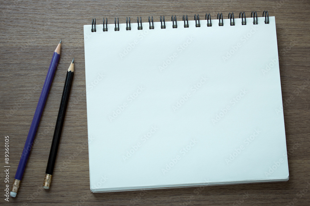 blank spiral notebook and pencil on dark wood background blank spiral notebook and pencil on dark wood background