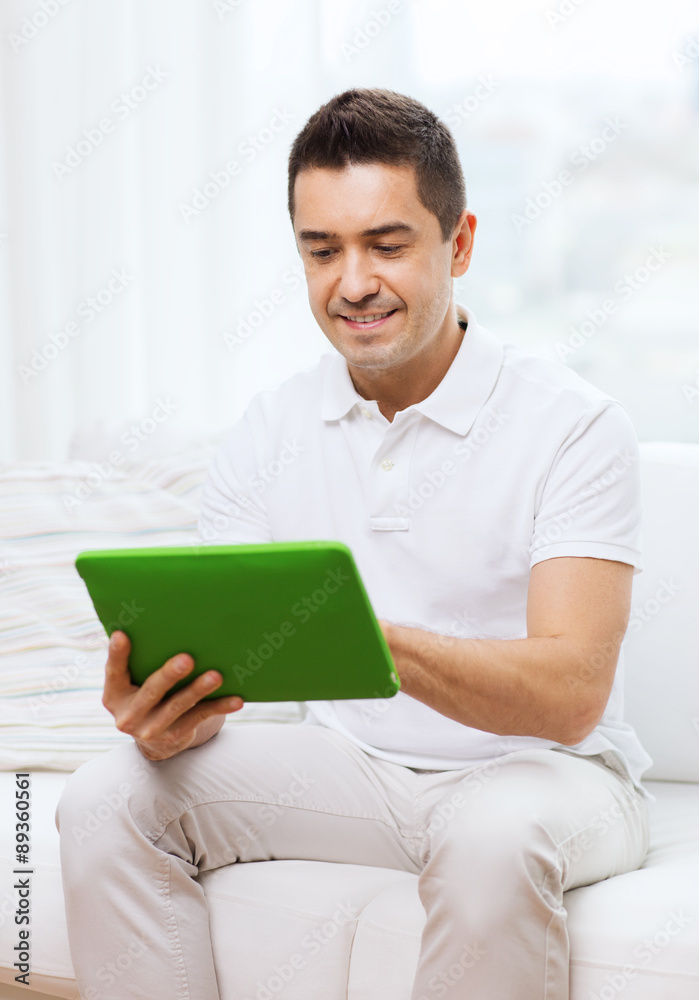 smiling man working with tablet pc at home smiling man working with tablet pc at home