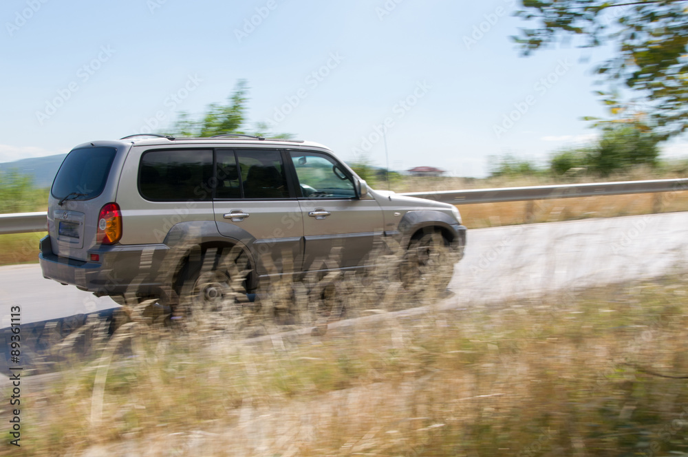 Fototapeta premium car driving at high speed in empty road