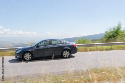  car driving at high speed in empty road