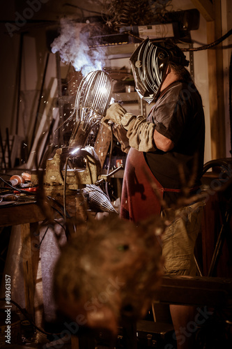 Fototapeta Naklejka Na Ścianę i Meble -  Metal worker standing in workshop