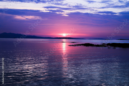 sunset above the sea © muangsatun