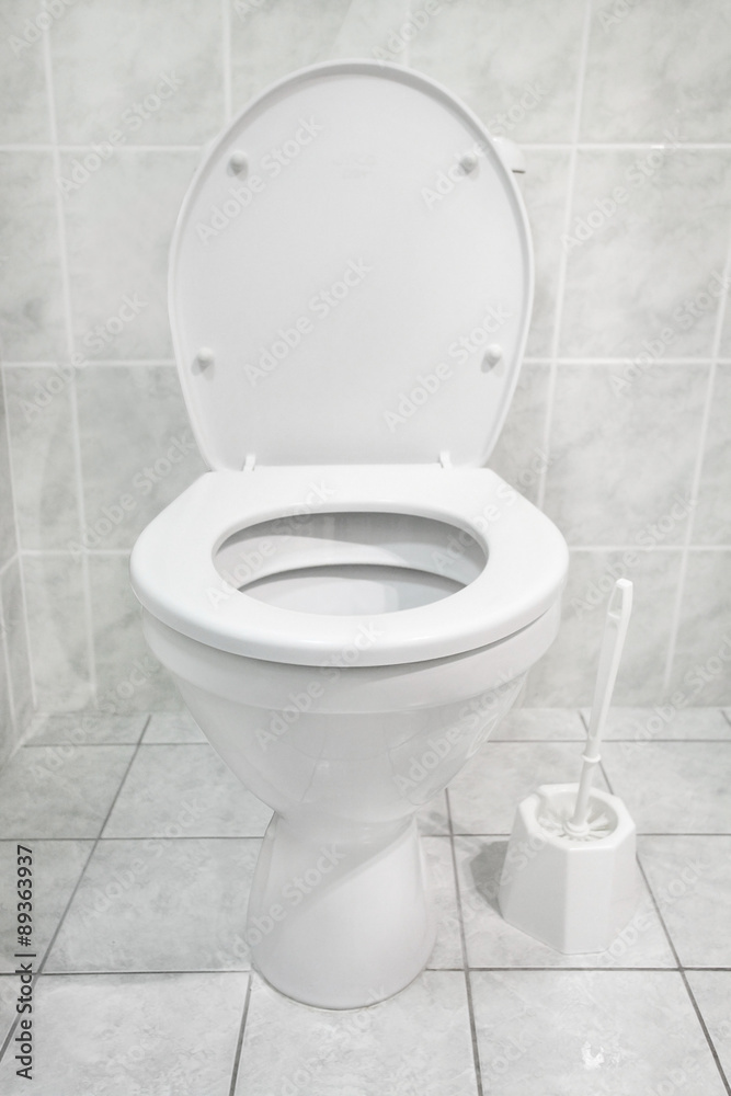 White toilet bowl in a modern bathroom. Hygiene concept. White toilet bowl in a modern bathroom. Hygiene concept.