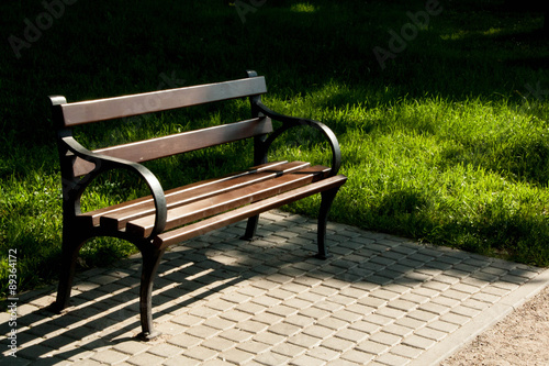 Stylish bench in summer park © alexx_60
