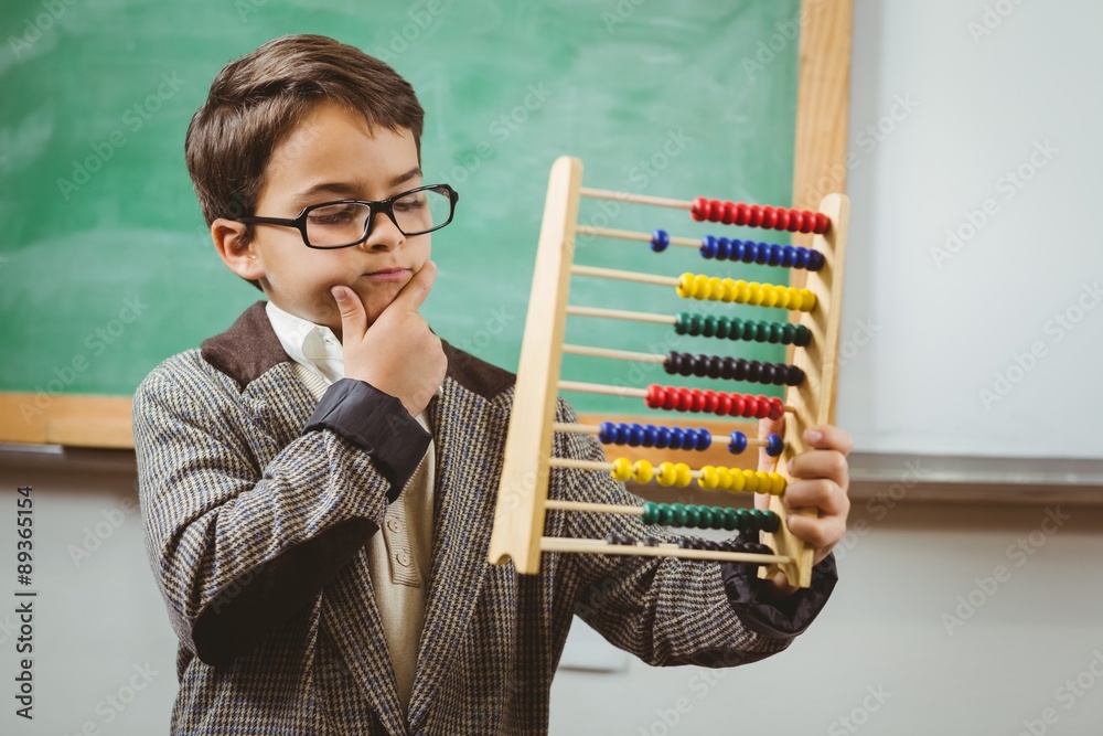 Obraz premium Pupil dressed up as teacher holding abacus