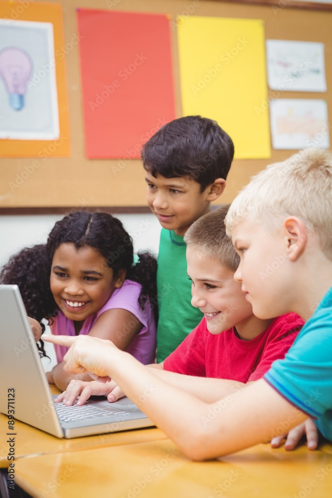 Pupils using a laptop in class