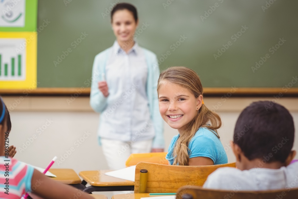 Pupil smiling at camera during class Pupil smiling at camera during class