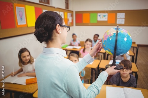 Teacher showing pupils a globe