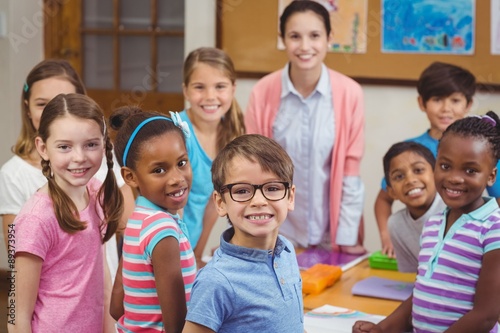 Teacher and pupils working at desk together