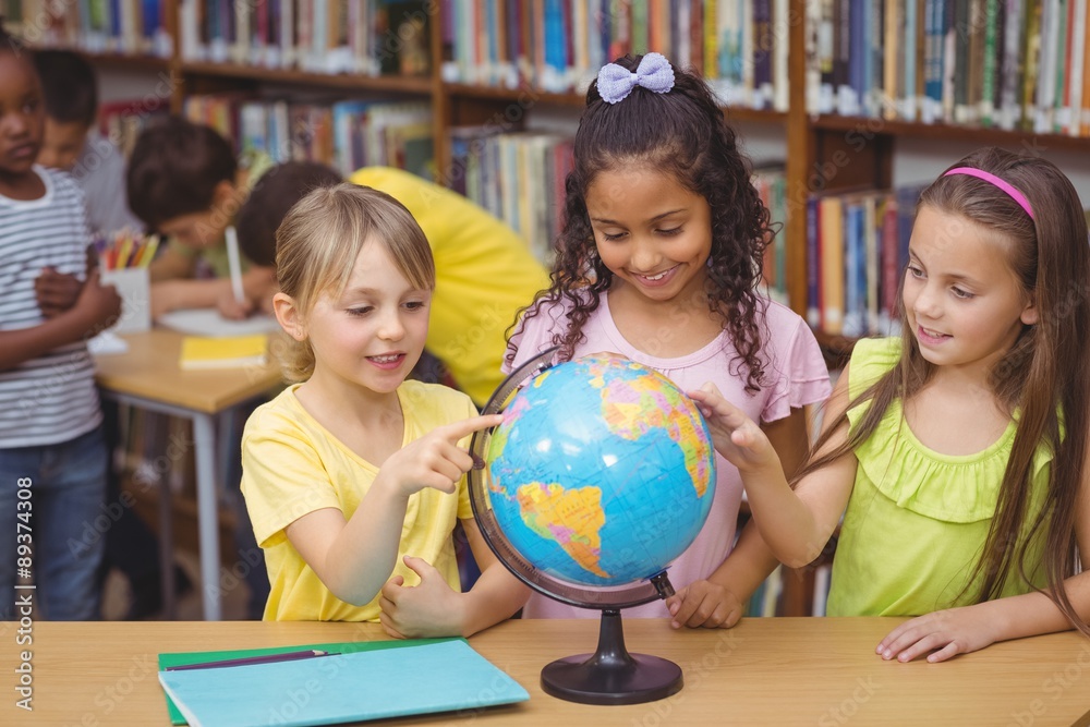 Fototapeta premium Pupils in library with globe