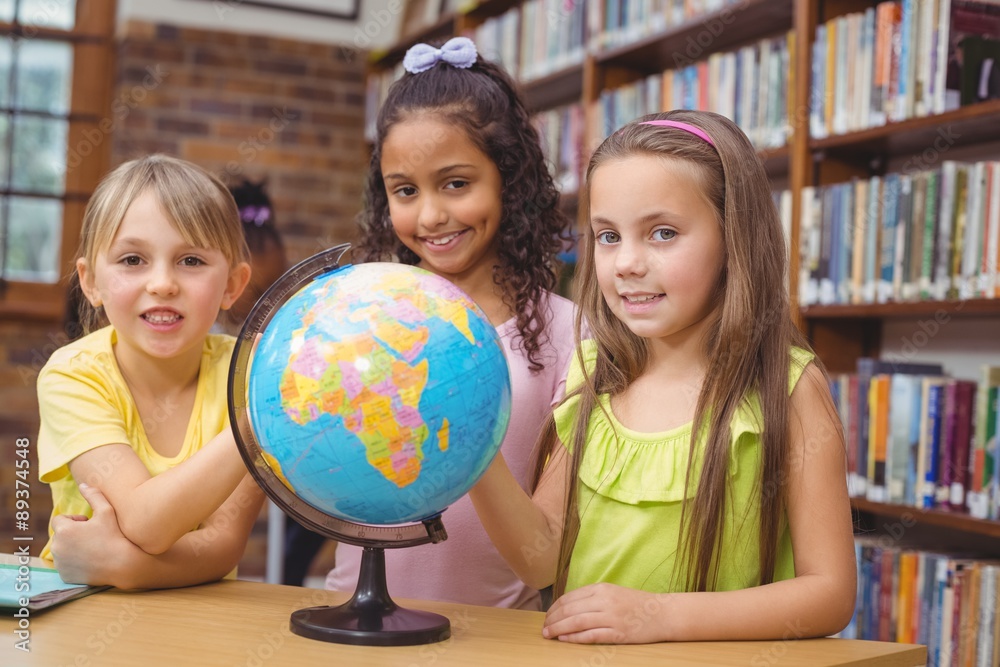 Fototapeta premium Pupils in library with globe