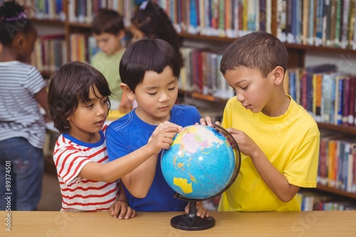 Pupils in library with globe