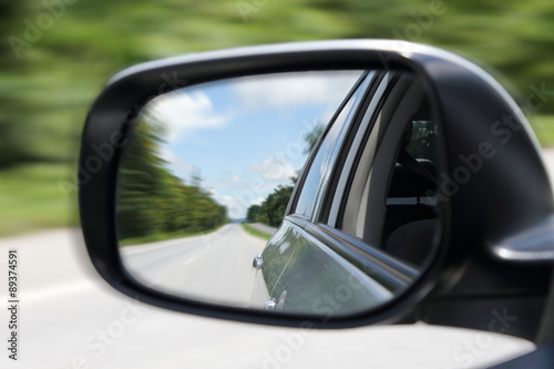 Photography image of street from the sideview mirror