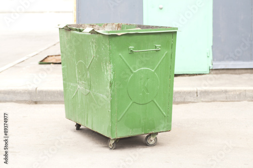 Green recycling container on the street