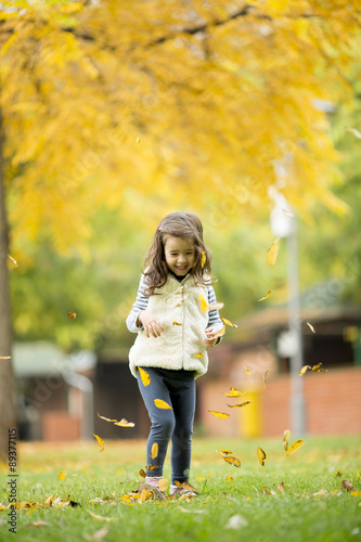 Little girl at the autumn park