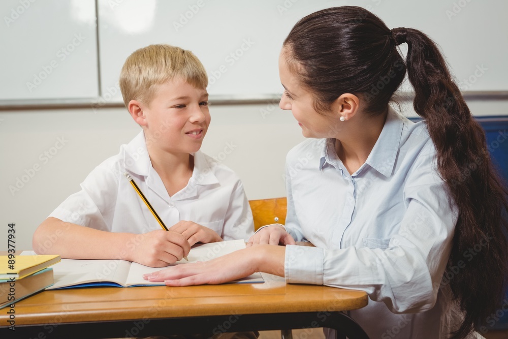 Teacher helping a student in class Teacher helping a student in class