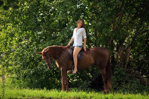 Pretty women posing with her horse
