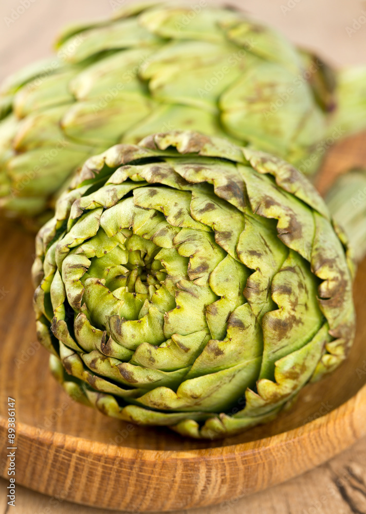 artichokes on wooden surface artichokes on wooden surface
