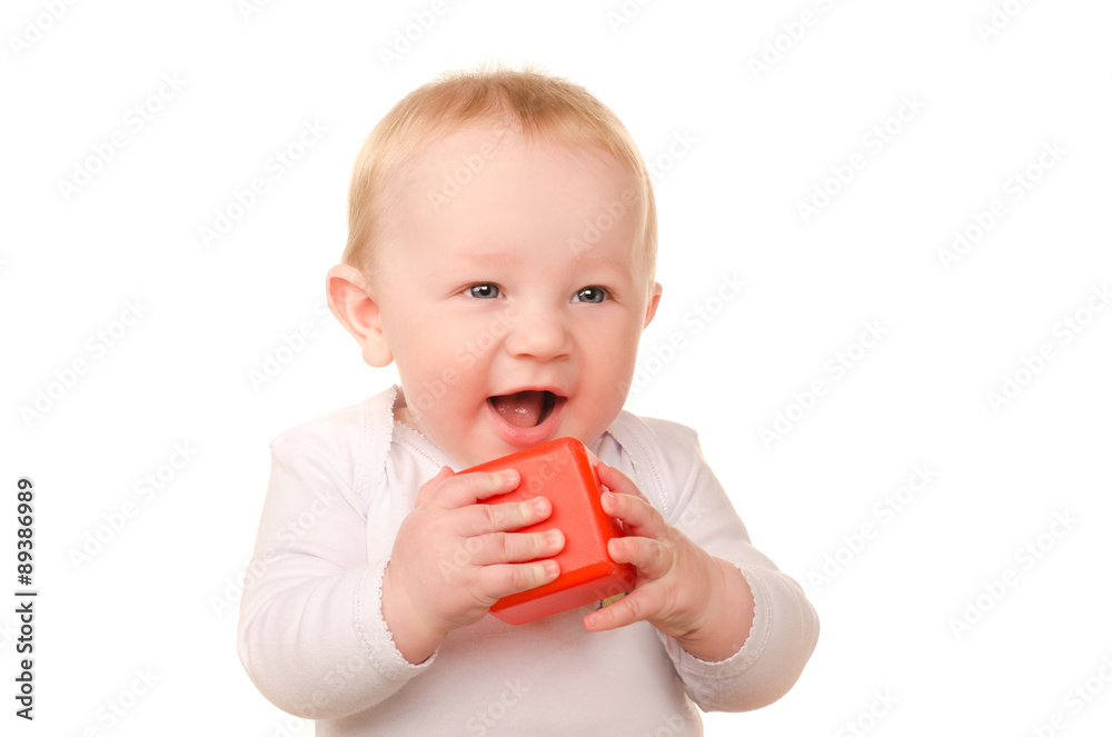 baby boy in white playing with toy red block baby boy in white playing with toy red block