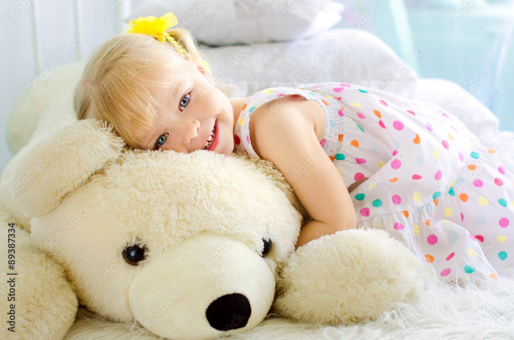 little girl embracing big white teddy bear little girl embracing big white teddy bear