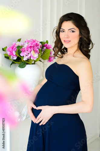 young attractive pregnant woman with flowers