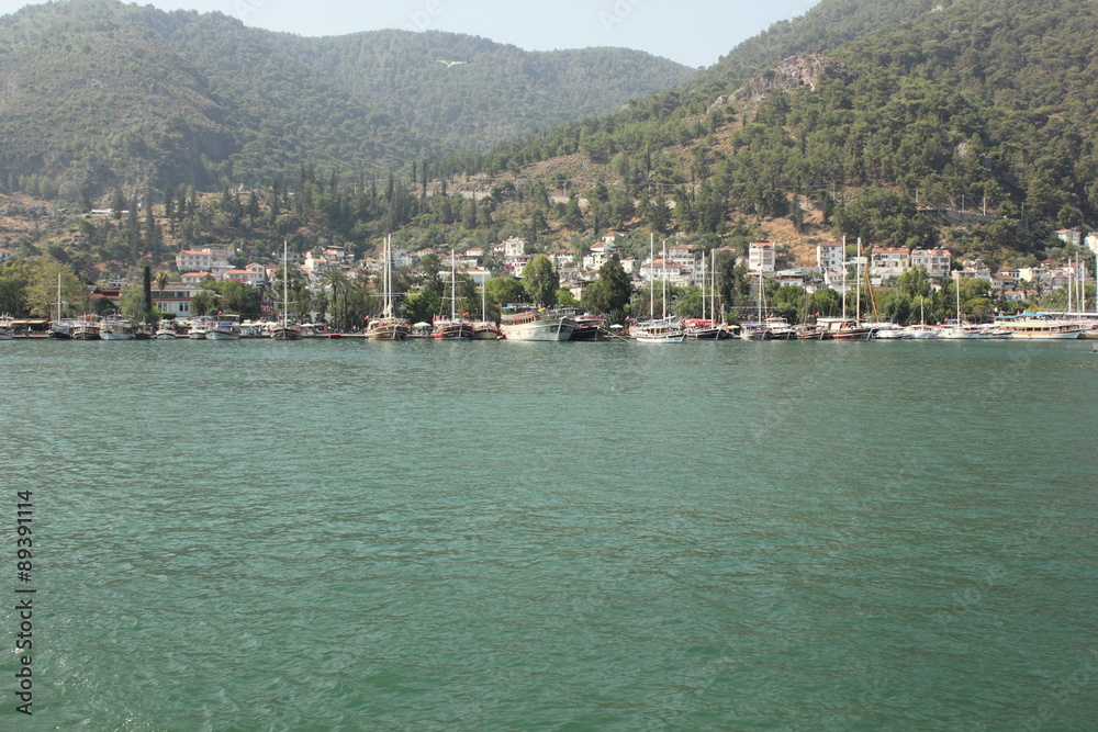 A Mountainous coastline with boats moored in turkey, 2015
