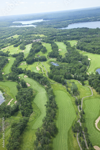 Aerial view of lakes area golf course showing several holes
