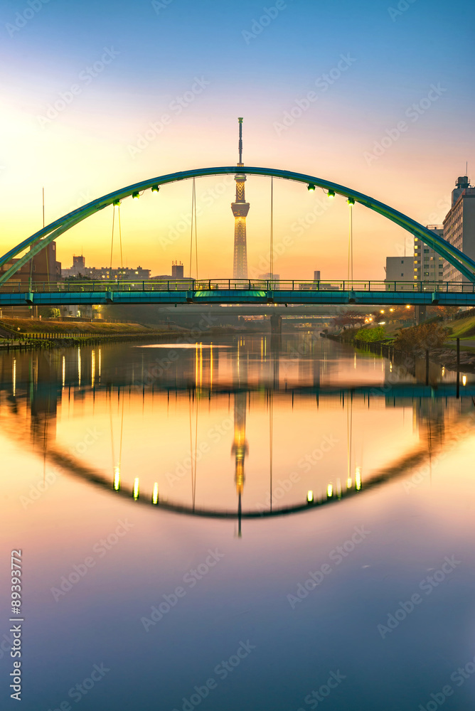 tokyo skytree and colorful bridge in refection in sumida river