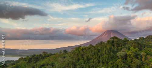Arenal Volcano at Sunrise in Costa Rica, as the sun reflects on the newly formed clouds