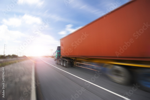 Generic big trucks speeding on the highway at sunset - Transport industry concept , big truck containers