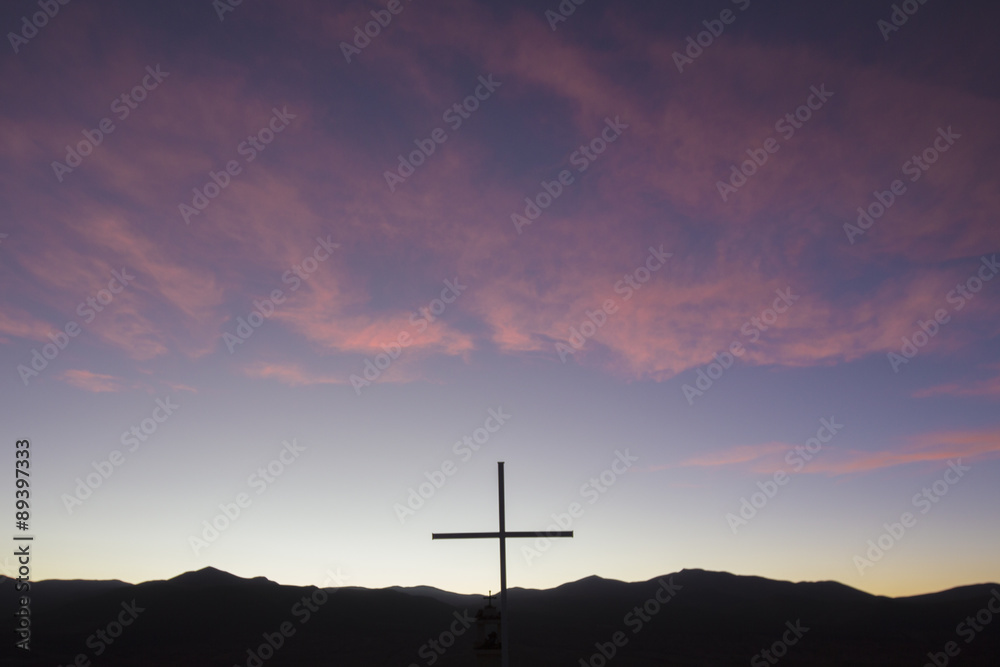 Silhouette of catholic cross in the mountain at sunset, Bolivia