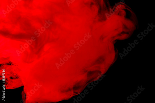 Abstract red-orange smoke hookah on a black background.