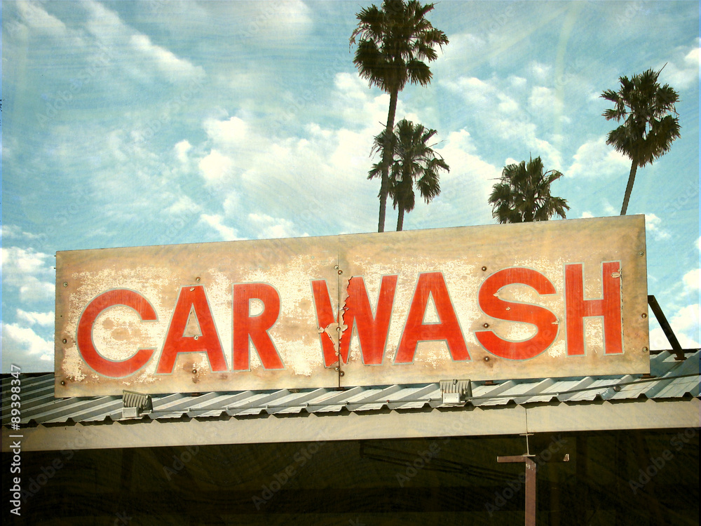 aged and worn vintage photo of car wash sign with palm trees Stock