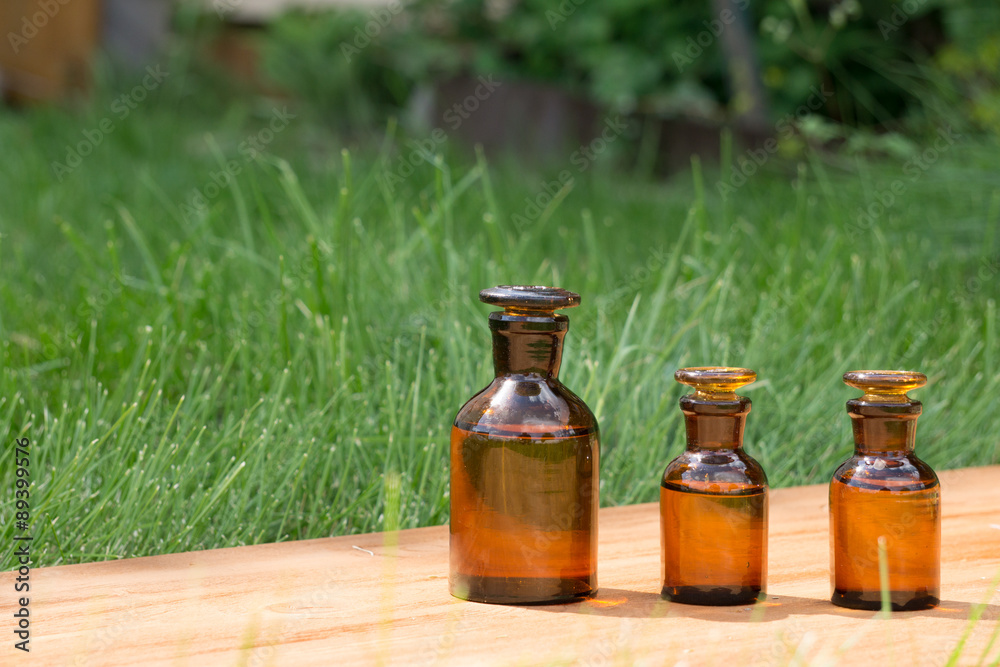 little brown bottles on booden board and grass little brown bottles on booden board and grass