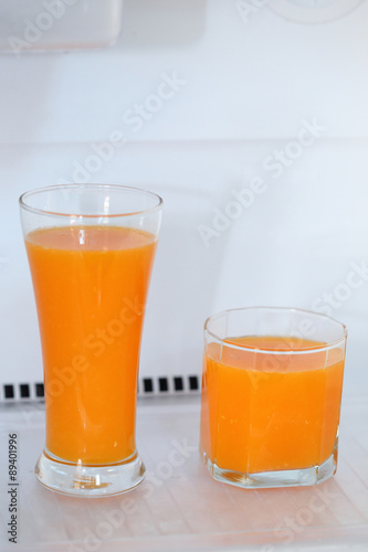 glass of fresh orange juice in refrigerator
