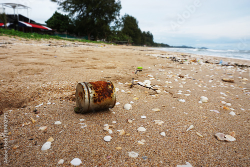 Old rusty cans on the beach
