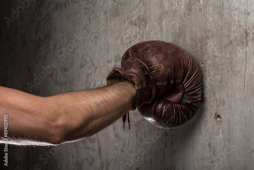 Tough caucasian male's hand in old vintage boxing gloves, ready to fight © Room 76 Photography