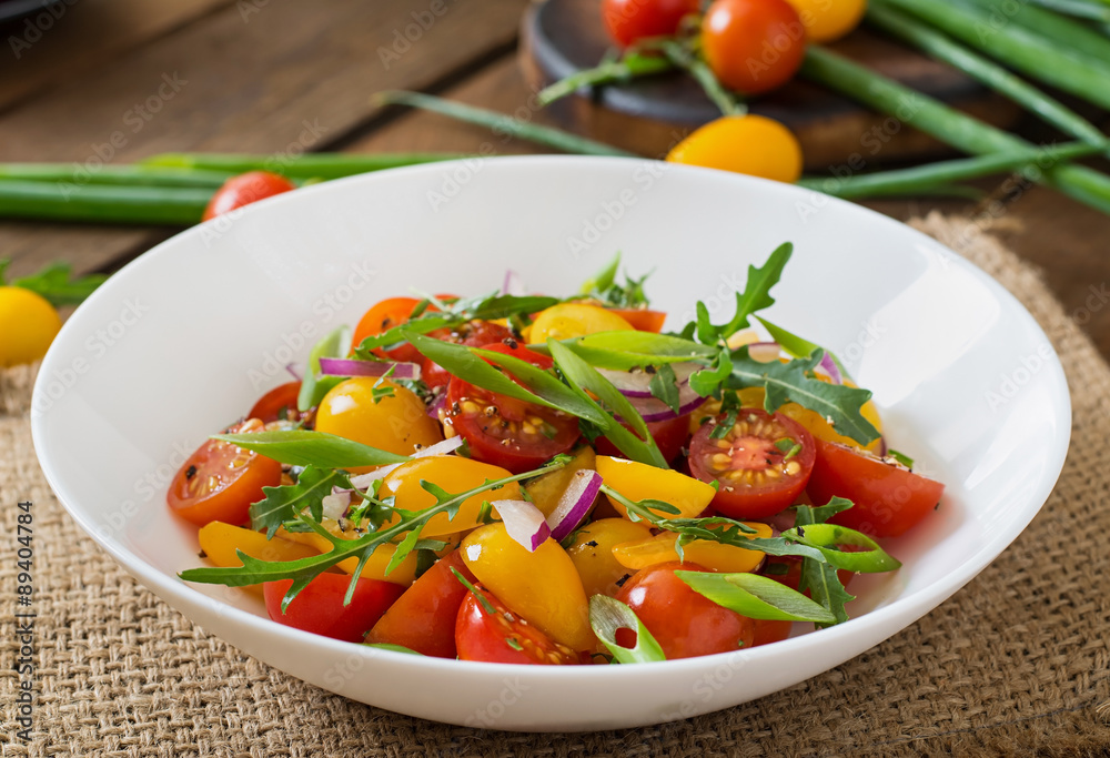 Salad of fresh cherry tomatoes with onion and arugula Salad of fresh cherry tomatoes with onion and arugula