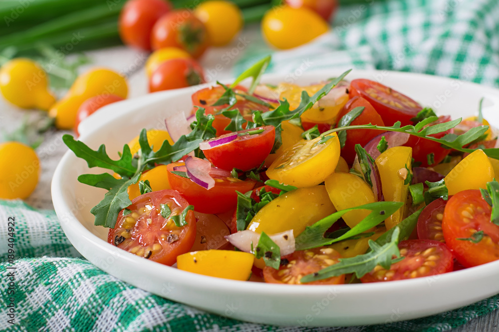 Salad of fresh cherry tomatoes with onion and arugula Salad of fresh cherry tomatoes with onion and arugula