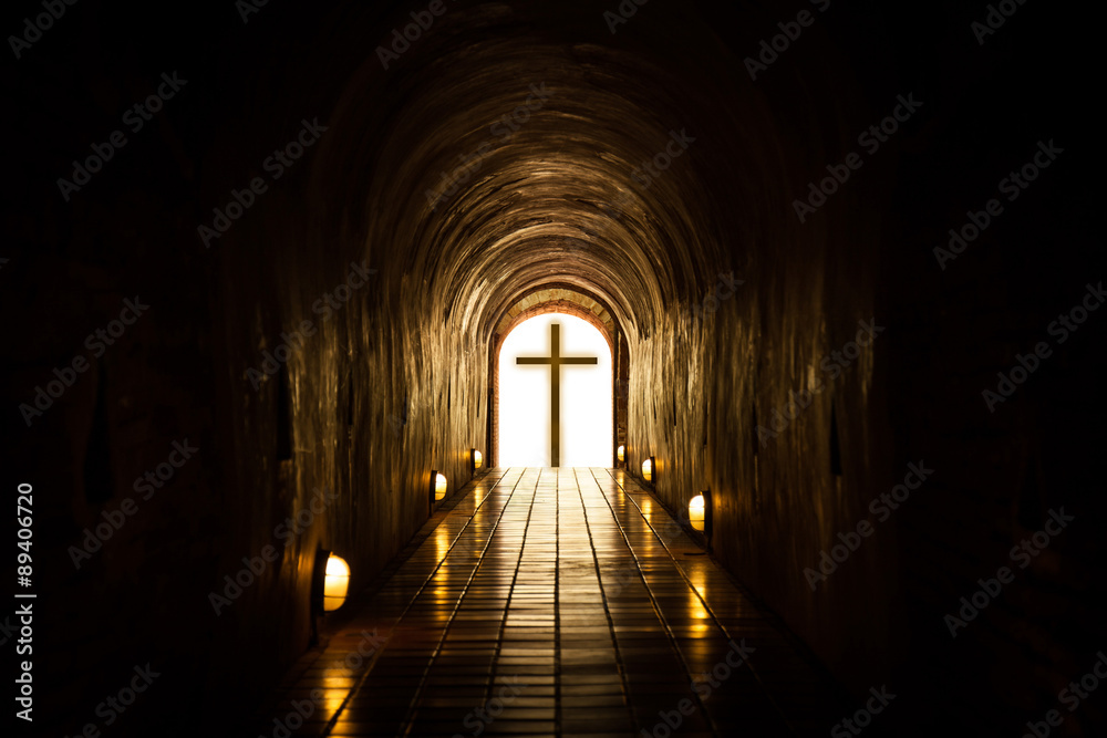 Silhouette of the cross at the end of tunnel.