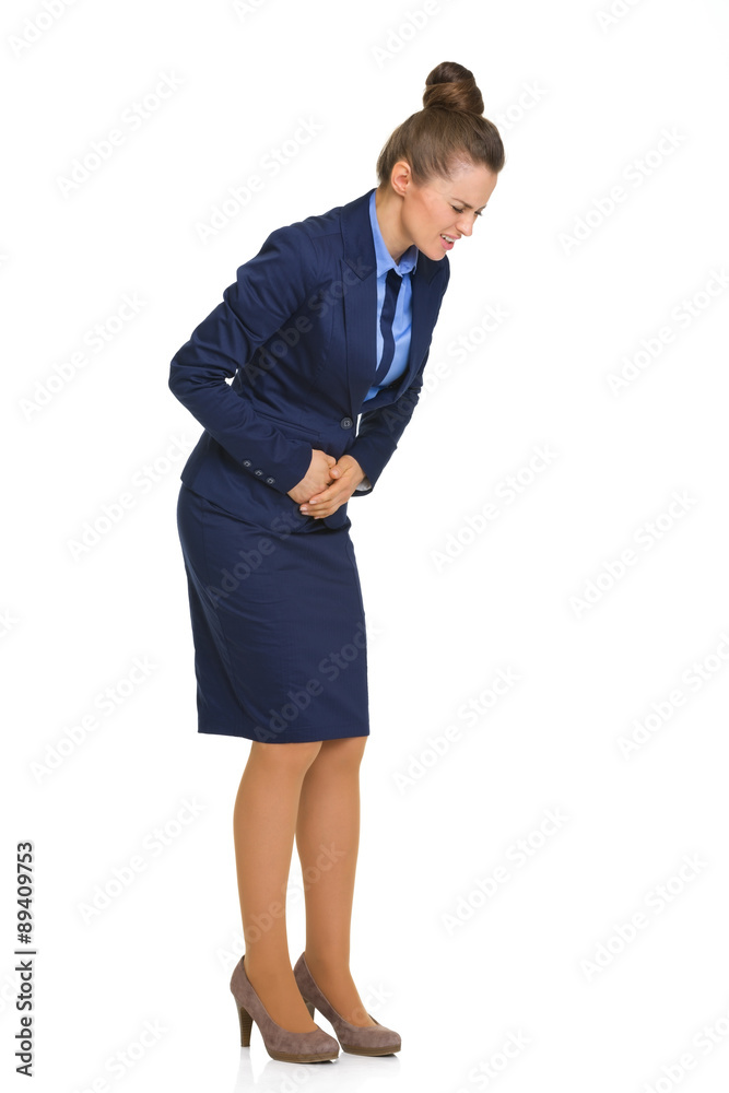 Businesswoman feeling sick and holding stomach in pain Businesswoman feeling sick and holding stomach in pain