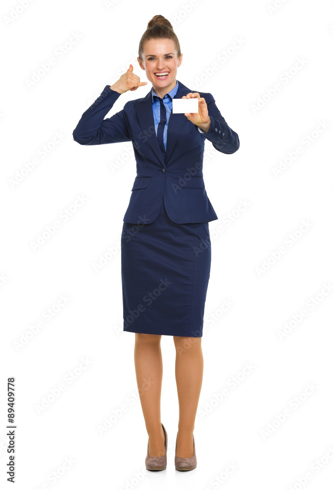 Happy businesswoman holding business card making telephone sign Happy businesswoman holding business card making telephone sign