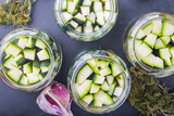 Marinated zucchini pieces in jars