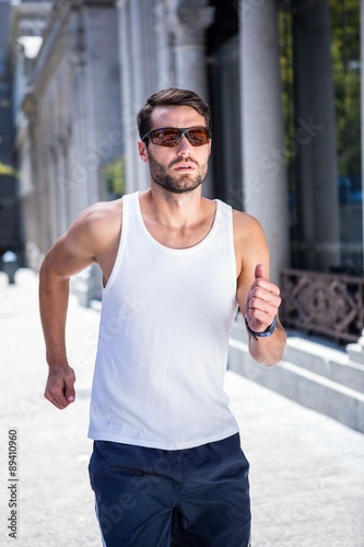 Handsome athlete with sunglasses jogging © WavebreakmediaMicro