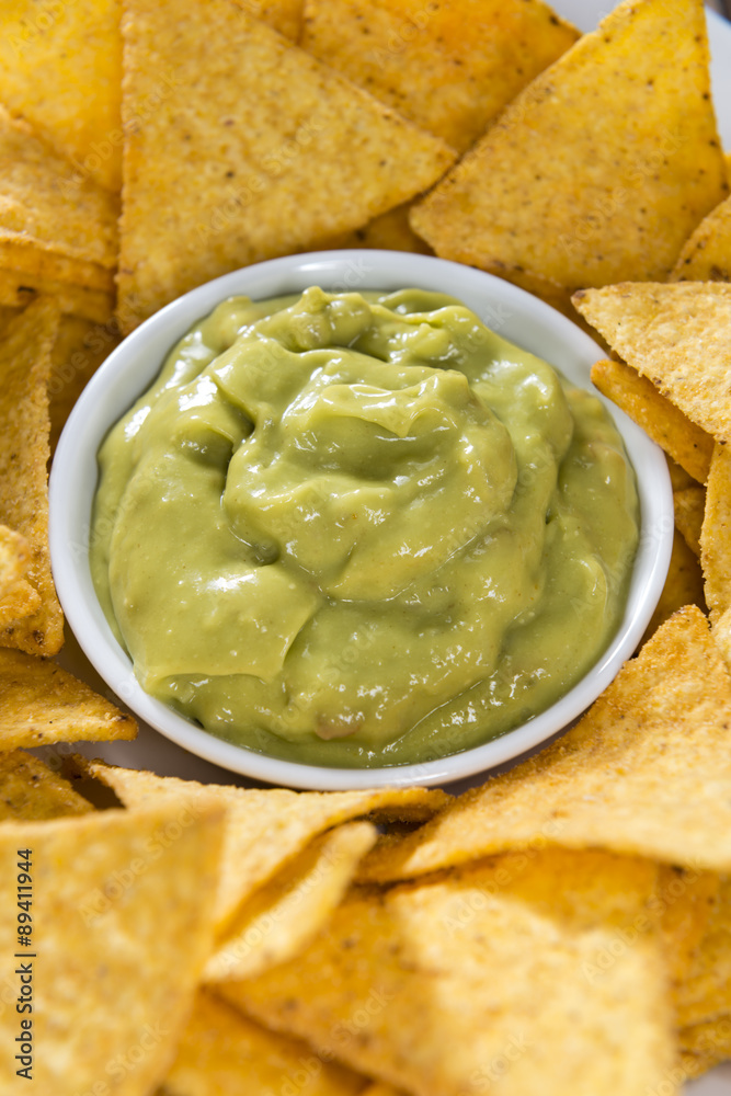 Some Nachos (with Guacamole) on wood Some Nachos (with Guacamole) on wood
