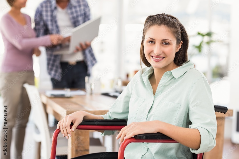 Smiling casual businesswoman in wheelchair Smiling casual businesswoman in wheelchair